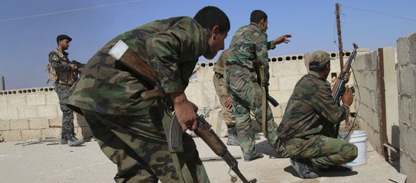 In this photo taken on Sunday, Oct. 11, 2015, Syrian soldiers fire repelling an attack in Achan, Hama province, Syria - Sputnik International