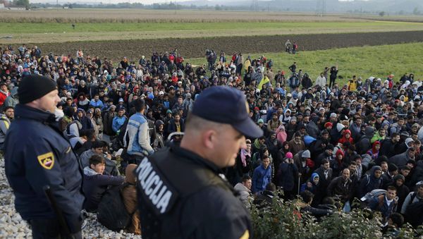 File Photo: Slovenian police officers watch as migrants walk from Dobova towards a transit camp in Brezice, Slovenia October 21, 2015 File Photo: Slovenian police officers watch as migrants walk from Dobova towards a transit camp in Brezice, Slovenia October 21, 2015 - Sputnik International