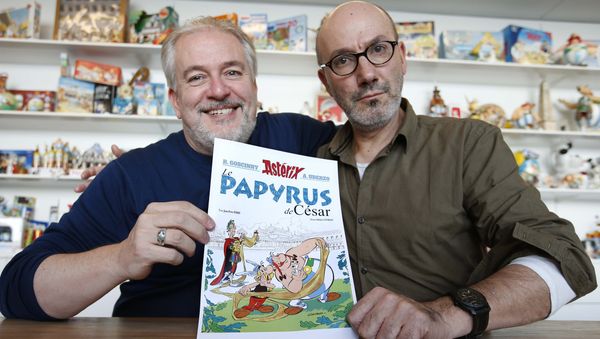 Author Jean-Yves Ferri (R) and illustrator Didier Conrad (L) pose with a print of the cover of their new comic book Le Papyrus de Cesar (Asterix and the Missing Scroll) in Vanves, Southern Paris, France, October 13, 2015 Author Jean-Yves Ferri (R) and illustrator Didier Conrad (L) pose with a print of the cover of their new comic book Le Papyrus de Cesar (Asterix and the Missing Scroll) in Vanves, Southern Paris, France, October 13, 2015 - Sputnik International