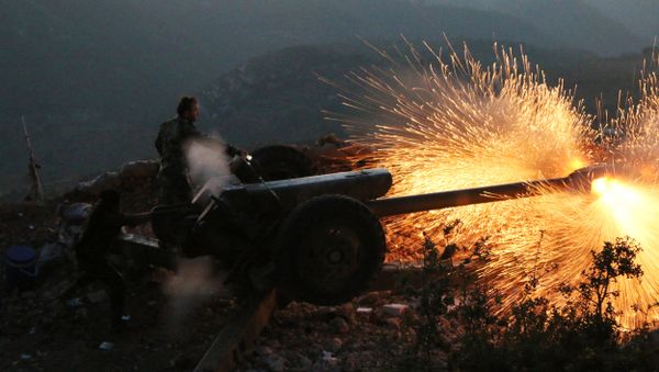 In this photo taken on Saturday, Oct. 10, 2015, Syrian army personnel fire a cannon in Latakia province, about 12 from the border with Turkey in Syria In this photo taken on Saturday, Oct. 10, 2015, Syrian army personnel fire a cannon in Latakia province, about 12 from the border with Turkey in Syria - Sputnik International