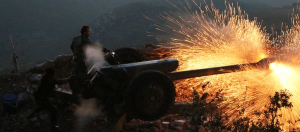In this photo taken on Saturday, Oct. 10, 2015, Syrian army personnel fire a cannon in Latakia province, about 12 from the border with Turkey in Syria - Sputnik International