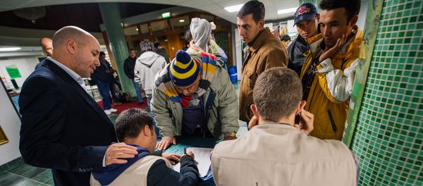 Abdallah Salah (L), President of Islamic Relief Sweden, helps refugee's as they register their names upon arrival to Stockholm central mosque on October 15, 2015 after many hours bus journey from the southern city of Malmo Abdallah Salah (L), President of Islamic Relief Sweden, helps refugee's as they register their names upon arrival to Stockholm central mosque on October 15, 2015 after many hours bus journey from the southern city of Malmo - Sputnik International