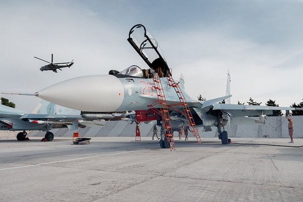 Russian Aerospace Forces Su-30SM Flanker-H super-maneuverable generation 4+ multirole jet fighters at Hmeymim air base near Latakia, Syria, all set for combat missions’ air support. A Russian Mi-24P Hind-F attack helicopter patrolling the airspace is seen in the background. - Sputnik International