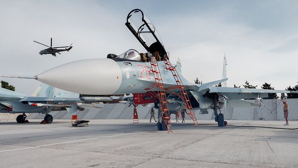 Russian Aerospace Forces Su-30SM Flanker-H super-maneuverable generation 4+ multirole jet fighters at Hmeymim air base near Latakia, Syria, all set for combat missions’ air support. A Russian Mi-24P Hind-F attack helicopter patrolling the airspace is seen in the background. - Sputnik International