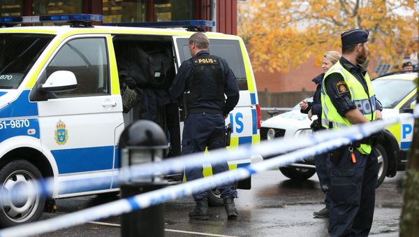 Police officers stand guard at a cordoned area after a masked man attacked people with a sword at a school in Trollhattan, western Sweden (photo used for illustration purpose) Police officers stand guard at a cordoned area after a masked man attacked people with a sword at a school in Trollhattan, western Sweden (photo used for illustration purpose) - Sputnik International