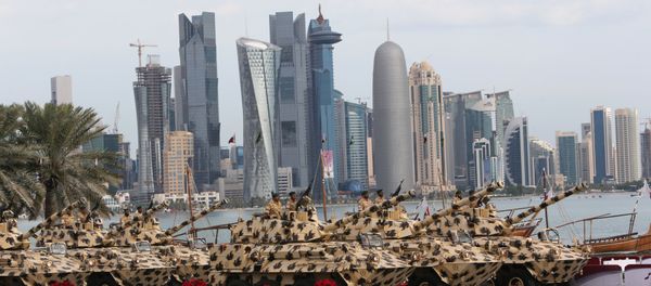 A general view show armoured vehicles rolling during the military parade marking the Gulf emirate's National Day celebrations in Doha on December 18, 2012 A general view show armoured vehicles rolling during the military parade marking the Gulf emirate's National Day celebrations in Doha on December 18, 2012 - Sputnik International