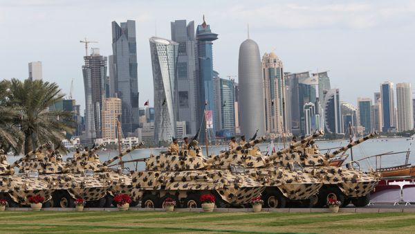 A general view show armoured vehicles rolling during the military parade marking the Gulf emirate's National Day celebrations in Doha on December 18, 2012 - Sputnik International