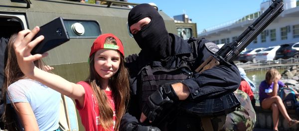 A girl poses for a selfie with a police officer during the 'Resort 2015. Kuban is a Safe Territory' project in the Krasnodar Territory - Sputnik International