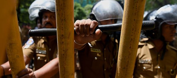 Sri Lankan police watch as Tamil protesters hold placards demanding the release of activists being held under tough anti-terror laws in the Sri Lankan capital Colombo on October 14, 2015 Sri Lankan police watch as Tamil protesters hold placards demanding the release of activists being held under tough anti-terror laws in the Sri Lankan capital Colombo on October 14, 2015 - Sputnik International