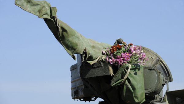 A tank of the Ukrainian forces, with flowers hung on its turret, rides from the front line near the village of Crymske in the Lugansk region on October 5, 2015 A tank of the Ukrainian forces, with flowers hung on its turret, rides from the front line near the village of Crymske in the Lugansk region on October 5, 2015 - Sputnik International