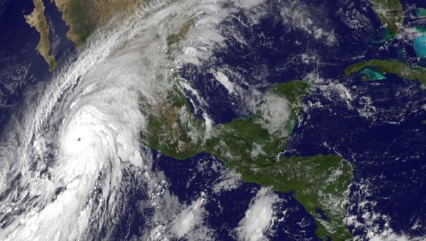 This satellite image taken at 10 a.m.. EDT on Friday, Oct. 23, 2015, and released by the National Oceanic and Atmospheric Administration shows Hurricane Patricia, left, moving over Mexico's Pacific Coast. This satellite image taken at 10 a.m.. EDT on Friday, Oct. 23, 2015, and released by the National Oceanic and Atmospheric Administration shows Hurricane Patricia, left, moving over Mexico's Pacific Coast. - Sputnik International