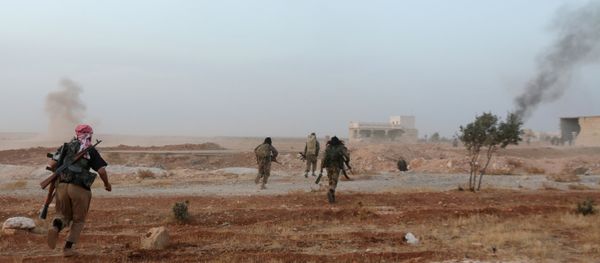 A picture taken on October 17, 2015 shows smoke billowing as Syrian opposition fighters run in the Mount Azzan area, 24 kms from the northern Syrian city of Aleppo, during reported fighting against forces loyal to Syrian President Bashar al-Assad A picture taken on October 17, 2015 shows smoke billowing as Syrian opposition fighters run in the Mount Azzan area, 24 kms from the northern Syrian city of Aleppo, during reported fighting against forces loyal to Syrian President Bashar al-Assad - Sputnik International
