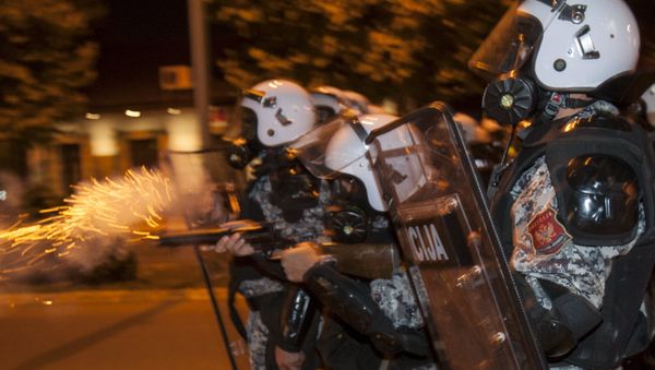 A riot policeman fires tear gas at protesters in front of the parliament building in Podgorica, Montenegro, October 24, 2015. - Sputnik International