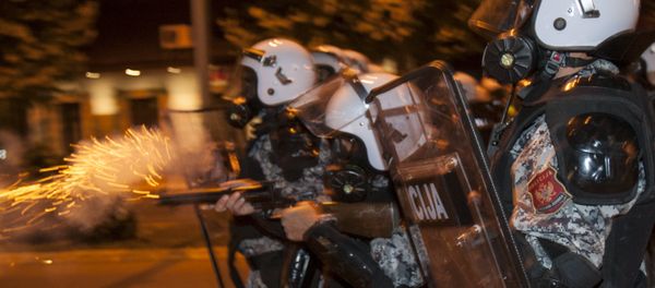A riot policeman fires tear gas at protesters in front of the parliament building in Podgorica, Montenegro, October 24, 2015. A riot policeman fires tear gas at protesters in front of the parliament building in Podgorica, Montenegro, October 24, 2015. - Sputnik International
