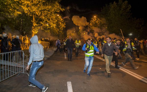 Protesters and journalists run from tear gas released by the police in front of the parliament building in Podgorica, Montenegro, October 24, 2015. - Sputnik International