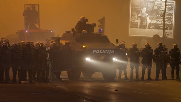 Riot police form a line with an armored vehicle during clashes with protesters in front of the parliament building in Podgorica, Montenegro, October 24, 2015. - Sputnik International