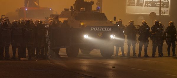 Riot police form a line with an armored vehicle during clashes with protesters in front of the parliament building in Podgorica, Montenegro, October 24, 2015. - Sputnik International