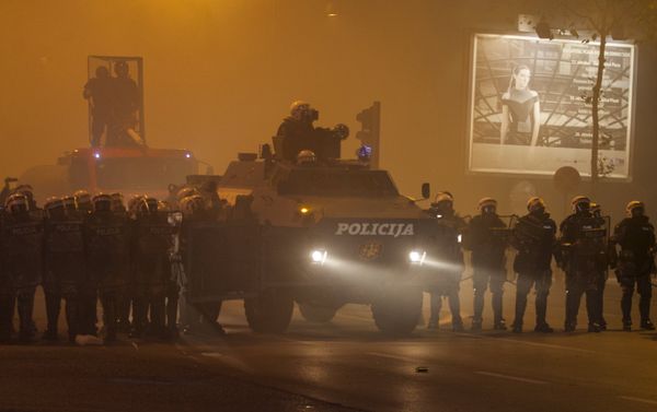 Riot police form a line with an armored vehicle during clashes with protesters in front of the parliament building in Podgorica, Montenegro, October 24, 2015. - Sputnik International