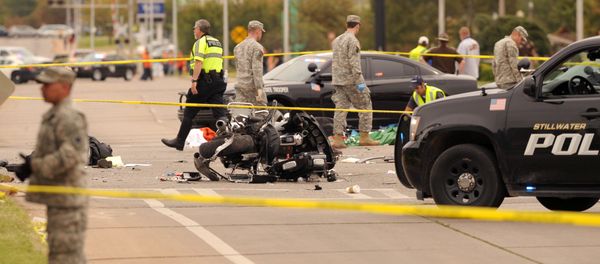 A damaged police motorcycle rests in the intersection after a vehicle crashed into a crowd of spectators during the Oklahoma State University homecoming parade, causing multiple injuries, on Saturday, Oct. 24, 2015 in Stillwater, Oka. A damaged police motorcycle rests in the intersection after a vehicle crashed into a crowd of spectators during the Oklahoma State University homecoming parade, causing multiple injuries, on Saturday, Oct. 24, 2015 in Stillwater, Oka. - Sputnik International
