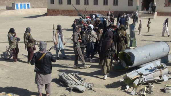 Taliban militants stand next to the wreckage of components jettisoned by a damaged aircraft, which the militants say they had hit. Taliban militants stand next to the wreckage of components jettisoned by a damaged aircraft, which the militants say they had hit. - Sputnik International