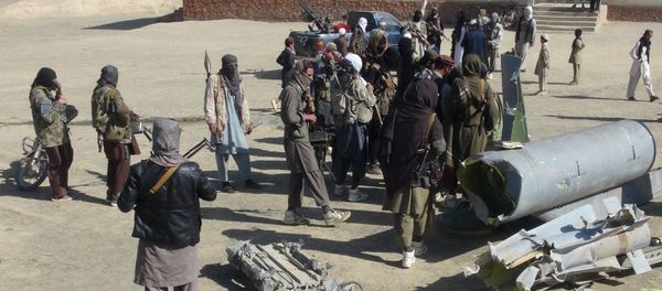 Taliban militants stand next to the wreckage of components jettisoned by a damaged aircraft, which the militants say they had hit. Taliban militants stand next to the wreckage of components jettisoned by a damaged aircraft, which the militants say they had hit. - Sputnik International