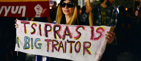 A woman holds a banner reading 'Tsipras is a big traitor', in front of the Greek parliament in Athens on October 16, 2015, while Greece's parliament is expected to approve later a first batch of reforms and tax cuts stemming from its third EU bailout. A woman holds a banner reading 'Tsipras is a big traitor', in front of the Greek parliament in Athens on October 16, 2015, while Greece's parliament is expected to approve later a first batch of reforms and tax cuts stemming from its third EU bailout. - Sputnik International
