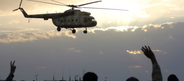 Libyans wave and flash the sign for victory at a military helicopter as flies during a military display in Libya's coastal city of Benghazi on May 15, 2012. Libyans wave and flash the sign for victory at a military helicopter as flies during a military display in Libya's coastal city of Benghazi on May 15, 2012. - Sputnik International