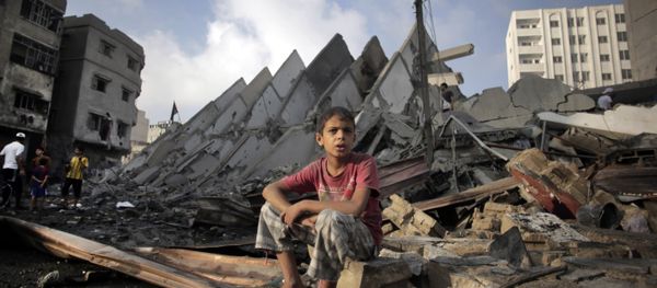 A Palestinian boy sits next to the destroyed 15-story Basha Tower following early morning Israeli airstrikes in Gaza City, Tuesday, Aug. 26, 2014. A Palestinian boy sits next to the destroyed 15-story Basha Tower following early morning Israeli airstrikes in Gaza City, Tuesday, Aug. 26, 2014. - Sputnik International