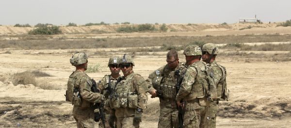 US soldiers prepare to participate in a training mission with Iraqi Army soldier, right, outside Baghdad, Iraq. (File) US soldiers prepare to participate in a training mission with Iraqi Army soldier, right, outside Baghdad, Iraq. (File) - Sputnik International