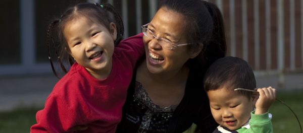 In this Monday, Oct. 17, 2011 photo, Wu Weiping, 35, plays with her daughter Wang Yile, 4, and her son Wu Yixiao, 2, near their home in Zhuji, in eastern China's Zhejiang province In this Monday, Oct. 17, 2011 photo, Wu Weiping, 35, plays with her daughter Wang Yile, 4, and her son Wu Yixiao, 2, near their home in Zhuji, in eastern China's Zhejiang province - Sputnik International