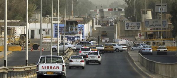 Iraqi security forces stand guard as vehicles move toward the gate of the heavily fortified Green Zone in Baghdad, Iraq, Monday, Oct. 5, 2015 Iraqi security forces stand guard as vehicles move toward the gate of the heavily fortified Green Zone in Baghdad, Iraq, Monday, Oct. 5, 2015 - Sputnik International