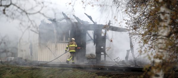 FILE - A Tuesday, Oct. 20, 2015 photo from files showing a firefighter working in the smoking remains of an accommodation home for asylum seekers near Munkedal in western Sweden FILE - A Tuesday, Oct. 20, 2015 photo from files showing a firefighter working in the smoking remains of an accommodation home for asylum seekers near Munkedal in western Sweden - Sputnik International