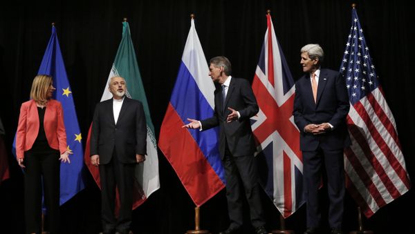 In this file photo, British Foreign Secretary Philip Hammond, second right, U.S. Secretary of State John Kerry, right, and European Union High Representative for Foreign Affairs and Security Policy Federica Mogherini, left, talk to Iranian Foreign Minister Mohammad Javad Zarif as the wait for Russian Foreign Minister Sergey Lavrov, not pictured, for a group picture at the Vienna International Center in Vienna, Austria In this file photo, British Foreign Secretary Philip Hammond, second right, U.S. Secretary of State John Kerry, right, and European Union High Representative for Foreign Affairs and Security Policy Federica Mogherini, left, talk to Iranian Foreign Minister Mohammad Javad Zarif as the wait for Russian Foreign Minister Sergey Lavrov, not pictured, for a group picture at the Vienna International Center in Vienna, Austria - Sputnik International