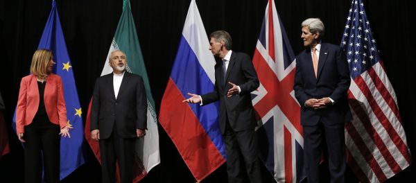 In this file photo, British Foreign Secretary Philip Hammond, second right, U.S. Secretary of State John Kerry, right, and European Union High Representative for Foreign Affairs and Security Policy Federica Mogherini, left, talk to Iranian Foreign Minister Mohammad Javad Zarif as the wait for Russian Foreign Minister Sergey Lavrov, not pictured, for a group picture at the Vienna International Center in Vienna, Austria In this file photo, British Foreign Secretary Philip Hammond, second right, U.S. Secretary of State John Kerry, right, and European Union High Representative for Foreign Affairs and Security Policy Federica Mogherini, left, talk to Iranian Foreign Minister Mohammad Javad Zarif as the wait for Russian Foreign Minister Sergey Lavrov, not pictured, for a group picture at the Vienna International Center in Vienna, Austria - Sputnik International