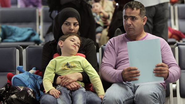 Syrian refugees wait to board a flight to Germany for temporary relocation, at Rafik Hariri International Airport in Beirut, Lebanon, Wednesday, Sept. 11, 2013. - Sputnik International