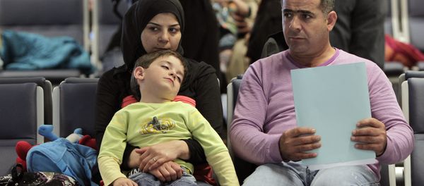 Syrian refugees wait to board a flight to Germany for temporary relocation, at Rafik Hariri International Airport in Beirut, Lebanon, Wednesday, Sept. 11, 2013. - Sputnik International