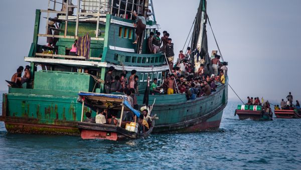 In this photo taken on May 20, 2015 shows Rohingya migrants resting on a boat off the coast near Kuala Simpang Tiga in Indonesia's East Aceh district of Aceh province before being rescued In this photo taken on May 20, 2015 shows Rohingya migrants resting on a boat off the coast near Kuala Simpang Tiga in Indonesia's East Aceh district of Aceh province before being rescued - Sputnik International