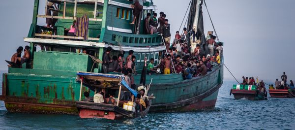 In this photo taken on May 20, 2015 shows Rohingya migrants resting on a boat off the coast near Kuala Simpang Tiga in Indonesia's East Aceh district of Aceh province before being rescued In this photo taken on May 20, 2015 shows Rohingya migrants resting on a boat off the coast near Kuala Simpang Tiga in Indonesia's East Aceh district of Aceh province before being rescued - Sputnik International