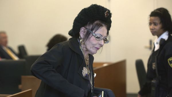 Witch priestess Lori Sforza holds a certificate of baptism as she returns to her seat after testifying in district court Wednesday, Oct. 28, 2015, in Salem, Mass. Sforza was seeking a restraining order against self-described warlock Christian Day, who she claimed harassed her during the past three years over the phone and on social media. - Sputnik International