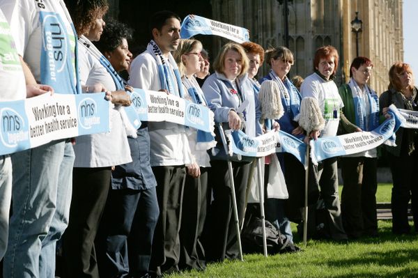 British National Health Service (NHS) staff gather outside Houses of Parliament in London to voice their feelings against potential staff cuts in hospitals, Wednesday, Nov. 1, 2006.. - Sputnik International