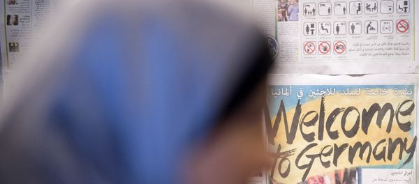 A woman waits in front of a wall newspaper in the initial reception center for asylum seekers in Halle/Saale, Germany, Friday, Oct. 16, 2015. A woman waits in front of a wall newspaper in the initial reception center for asylum seekers in Halle/Saale, Germany, Friday, Oct. 16, 2015. - Sputnik International