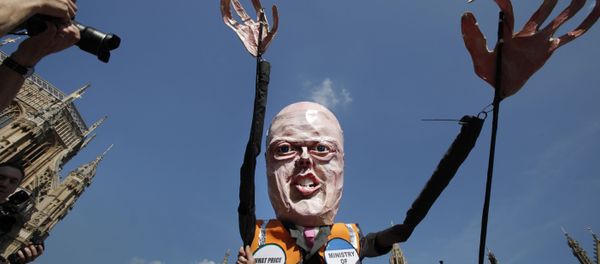 A protester carrying a puppet depicting Chris Grayling in central London, Tuesday, April 1, 2014. - Sputnik International