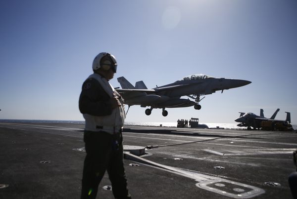 A US Navy crew member looks at an F/A-18 Super Hornet fighter landing onto the deck of the USS Ronald Reagan, a Nimitz-class nuclear-powered aircraft carrier, during a joint naval drill between South Korea and the US in the West Sea off South Korea on October 28, 2015 A US Navy crew member looks at an F/A-18 Super Hornet fighter landing onto the deck of the USS Ronald Reagan, a Nimitz-class nuclear-powered aircraft carrier, during a joint naval drill between South Korea and the US in the West Sea off South Korea on October 28, 2015 - Sputnik International