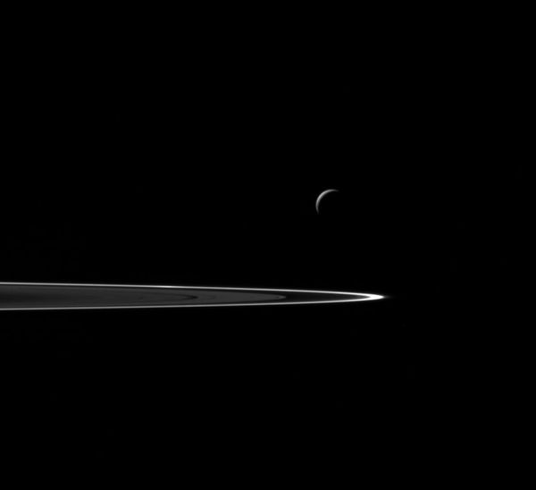 Following a successful close flyby of Enceladus, NASA's Cassini spacecraft captured this artful composition of the icy moon with Saturn's rings beyond - Sputnik International
