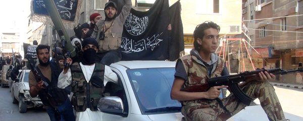 Islamic fighters from the al-Qaida group in the Levant, Al-Nusra Front, wave their movement's flag as they parade at the Yarmuk Palestinian refugee camp, south of Damascus, to denounce Israel’s military offensive on the Gaza Strip, on July 28, 2014. Islamic fighters from the al-Qaida group in the Levant, Al-Nusra Front, wave their movement's flag as they parade at the Yarmuk Palestinian refugee camp, south of Damascus, to denounce Israel’s military offensive on the Gaza Strip, on July 28, 2014. - Sputnik International