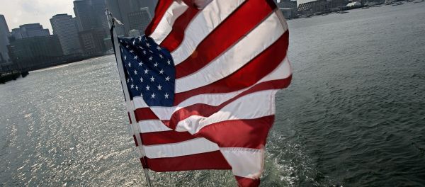 A United States flag flies on a ship of Massachusetts Bay Lines, Inc., against Boston skyline during Birth of A Nation Harbor Tours in Boston, Tuesday, July 11, 2006 - Sputnik International