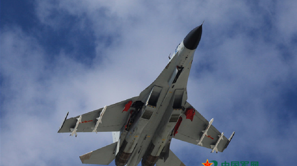 A J-11 fighter flies above the South China Sea on Oct. 30, 2015. An aviation division under the South China Sea Fleet of the Chinese PLA Navy carried out on Friday training on real air battle tactics. - Sputnik International