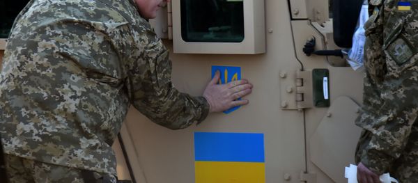 Ukrainian President Petro Poroshenko sticks an Ukrainian flag and the state emblem on an armoured vehicle at Kiev airport on March 25, 2015 during a welcoming ceremony of the first US plane delivery of non-lethal aid, including 10 Humvee vehicles Ukrainian President Petro Poroshenko sticks an Ukrainian flag and the state emblem on an armoured vehicle at Kiev airport on March 25, 2015 during a welcoming ceremony of the first US plane delivery of non-lethal aid, including 10 Humvee vehicles - Sputnik International