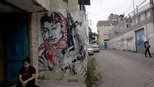 A Palestinian girl sits at the entrance of her family's house at Aida Refugee camp. A Palestinian girl sits at the entrance of her family's house at Aida Refugee camp. - Sputnik International