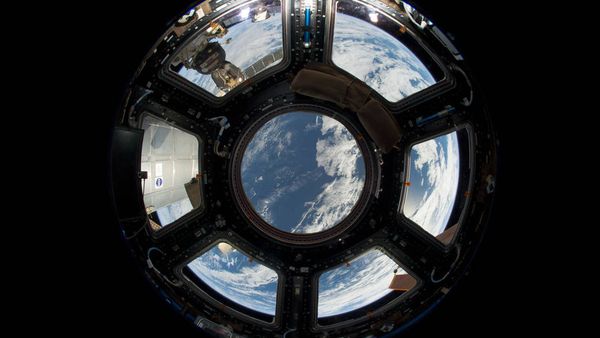 A view of Earth as seen from the Cupola on the Earth-facing side of the International Space Station. Visible in the top left foreground is a Russian Soyuz crew capsule. In the lower right corner, a solar array panel can be seen. A view of Earth as seen from the Cupola on the Earth-facing side of the International Space Station. Visible in the top left foreground is a Russian Soyuz crew capsule. In the lower right corner, a solar array panel can be seen. - Sputnik International